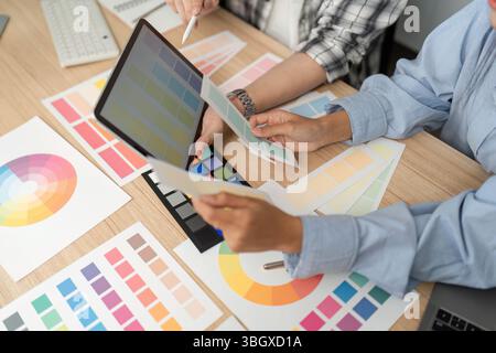 UX and UI Design Review. Designers analyzing color palettes and digital concepts. Stock Photo