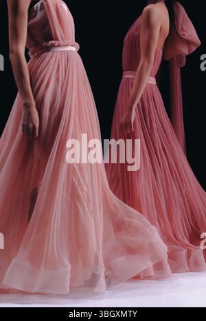 Women's fashion details of long pink satin dresses on female figures, designer elegant cloth collection Stock Photo