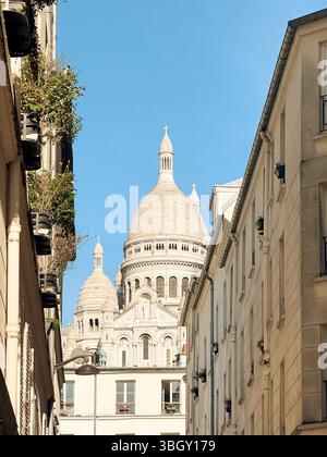 The famous Sacre-coeur basilica between haussmann buildings in Paris in ...