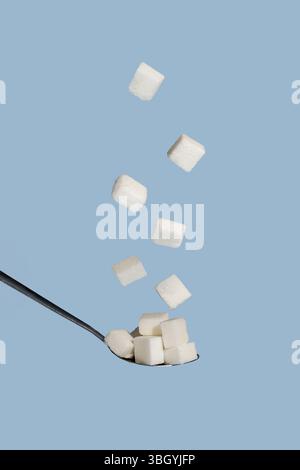 Sugar cubes in a spoon, abstract sugar addiction concept Stock Photo