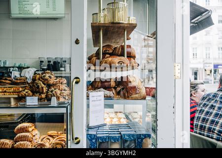 Bakery window filled with croissants and pastries on display Stock Photo