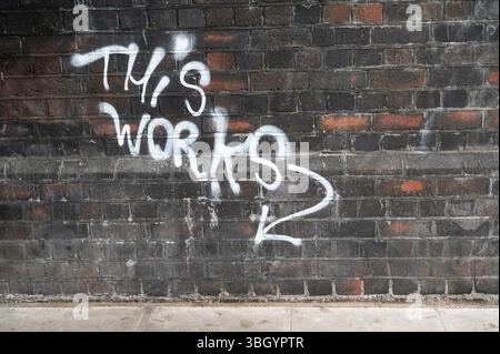 Hackney, London.. Writing on a brick wall saying 'This works'. Stock Photo