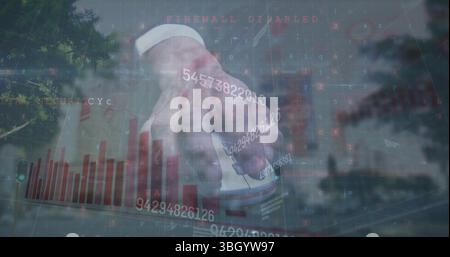 Image of numbers and graph over hand of caucasian man holding mouse and cityscape Stock Photo