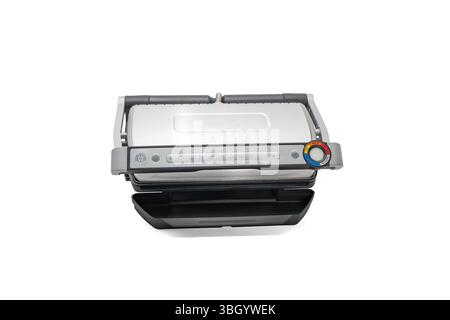 Contact grill closed - control panel visible isolated on white. A modern contact grill in a closed position with a digital control panel and temperatu Stock Photo