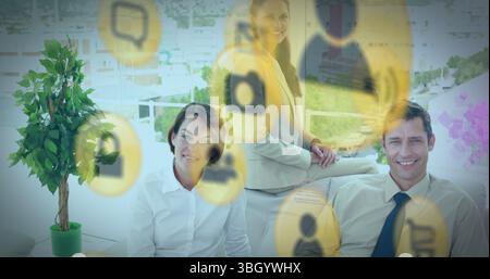 Collaborating team in business attire discussing ideas on balcony with floating icons, potted plant Stock Photo