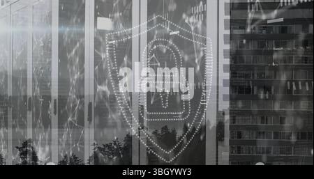 Displaying dotted shield outline enclosing padlock icon on office glass facade, with network lines Stock Photo
