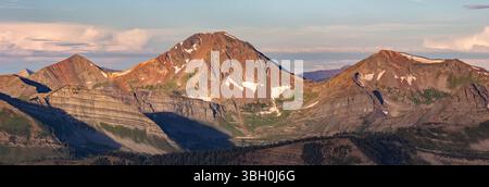 Colorful Colorado 12ers Ruby Peak and Afley Peak are overshadowed by 13er Mount Owen, the tallest mountain in the Ruby Range near Crested Butte. Stock Photo