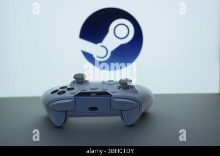 Game controller in front of Steam logo on a white background Stock ...