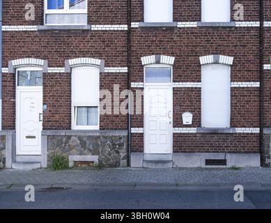 Herstal, Liege, Belgium, AUG 11, 2024 - Brick stone facade of modest houses in a row, Europe Stock Photo