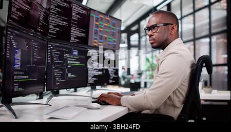 African American Programmer Developing Web Software In Office Setting Stock Photo