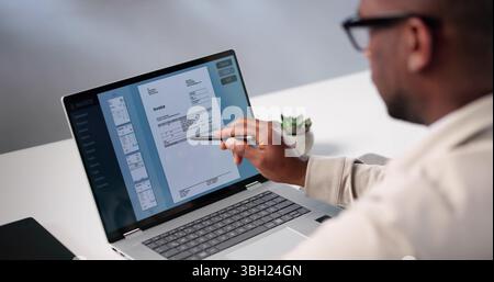 Busy Accountant Uses Invoice Software To Calculate Taxes For Clients. Stock Photo