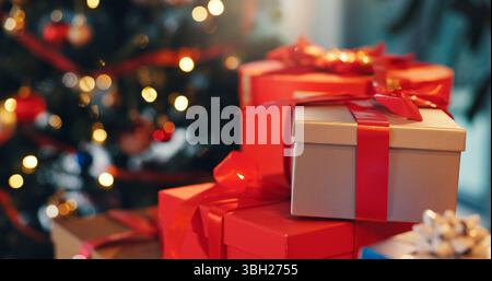 Christmas, boxes and gifts in home for celebration, party or event with festive tradition. Decorations, packages and cardboard presents with ribbon by Stock Photo