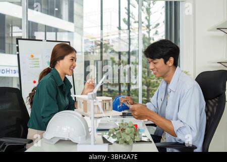 ESG and Sustainability. Engineers collaborating on eco-friendly building design. Stock Photo