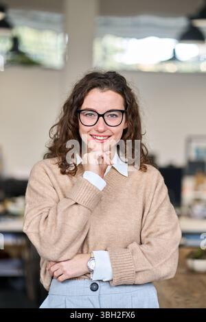 Young happy professional business woman wearing glasses, vertical portrait. Stock Photo