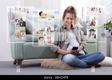 Happy young woman using smartphone to browse social media content through futuristic virtual screens in augmented reality at home. Modern lifestyle an Stock Photo