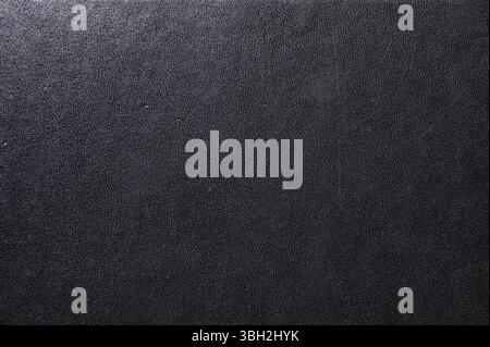 Black leather book cover close up. Abstract black leather sofa background. Stock Photo