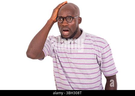 amazed young man wearing optical glasses while holding hand on head. Stock Photo