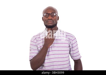 young man wearing optical glasses and touching beard under chin with finger. Stock Photo