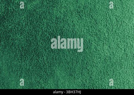 Close up, macro structure of green suede fabric with abstract embossed shabby, messy texture. Upholstery, decorative cloth structure, canvas for home Stock Photo