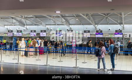 Larnaca, Cyprus, 5 May 2025,  Large, spacious hall inside an airport terminal with passengers and check-in counters. Stock Photo