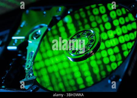 moving hard drive head with green data on drive Stock Photo
