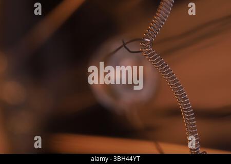 Tungsten filament, an incandescent light bulb, macro view, Metal texture in macro, silver wire Stock Photo