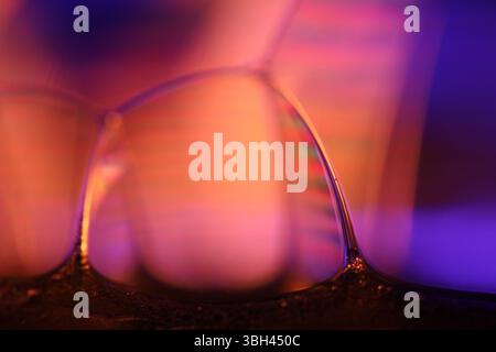 Orange and purple liquid glass, phenomenal liquid effects, bright orange reflections, chemical background Stock Photo