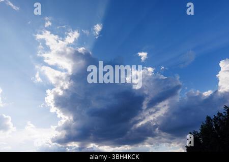 Sun glowing behind a dark cloud, Finland Stock Photo