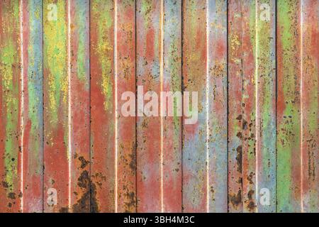 Rusty colorful rolling shutter. Rusty and coating color decay, steel rolling shutter. Ideal for urban and creative background Stock Photo