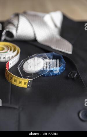 Jacket and tie detail with tailor meter and pins. Concept of Italian tailoring. Quality, style, made in Italy Stock Photo