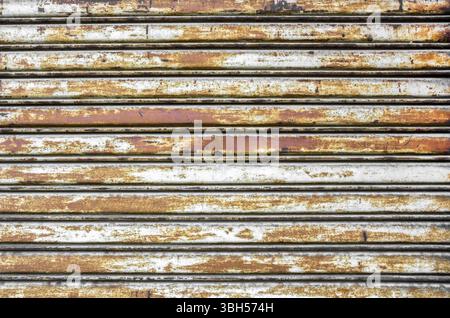 Background photo of a rusty old iron rolling shutter. Ideal for your grungy creative background Stock Photo