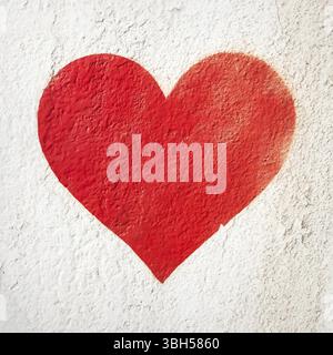 One red heart painted on concrete fence backdrop. Red love heart painted on wall background. Happy Valentines Day Stock Photo
