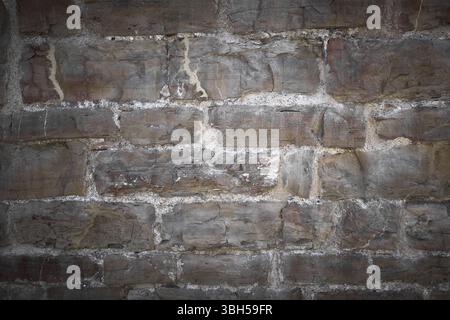 Front view of a stone wall slightly illuminated Stock Photo