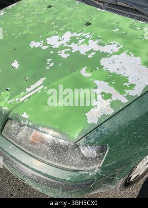 Cracked and peeling paint on an old car for background Stock Photo