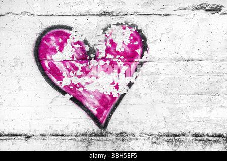 Painted pink abstract heart shape love symbol, dirty wall background, metaphor to urban and romantic valentine, grunge style Stock Photo