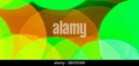 Vibrant Abstract Bokeh Background Featuring Overlapping Green Orange and Yellow Blurred Glowing Lights Effect Stock Photo