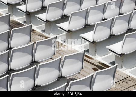 Rows of grey empty plastic seats. Stock Photo