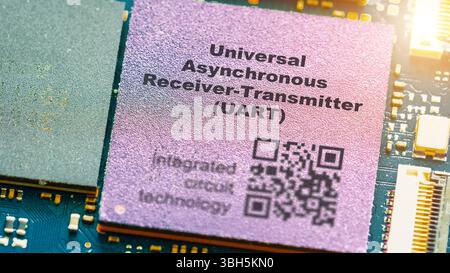 Universal asynchronous receiver-transmitter (UART). Microchip for serial communication between devices. Stock Photo