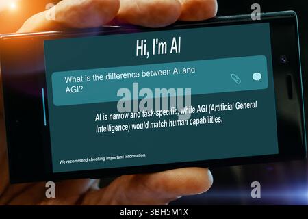 Question for AI on tablet screen. What is the difference between. AI and. AGI? Stock Photo