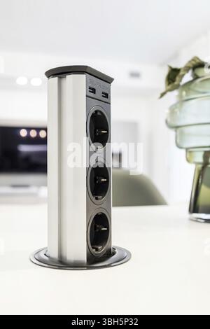 Table built-in socket. Fixed retractable power strip for home and office. New technology. Modern style Stock Photo