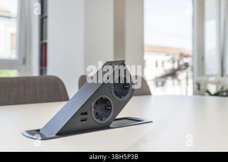 Table built-in socket. Fixed retractable power strip for home and office. New technology. Modern style Stock Photo