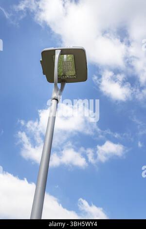 Led street lamp post on blue sky background with white clouds. Led lights saving electrical energy Stock Photo
