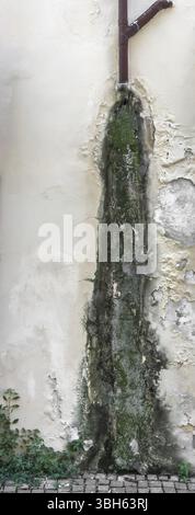 Rain water on the wall causing mold and peeling paint Stock Photo