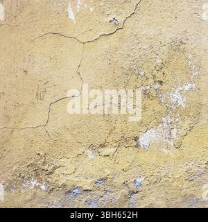 Wall old textured background. Grunge plaster wall with yellow scratched background. Old wall with peel swamp color stucco texture. Rough abstract surf Stock Photo