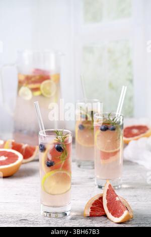 Paloma cocktail or lemonade with lime, grapefruit, blueberries and rosemary. Refreshing organic drink Stock Photo