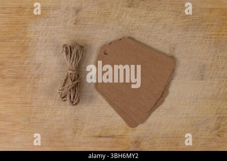 Vintage Cardboard Blank Tags Craft or Label on Wooden Surface Stock Photo
