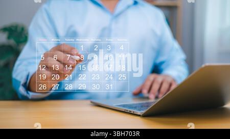 Person using a digital calendar on a laptop, symbolizing effective time management, business planning, and deadline tracking. Ideal for productivity, Stock Photo