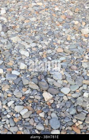 mooth pebbles background. variety of smooth, natural rocks with different shapes and textures Stock Photo