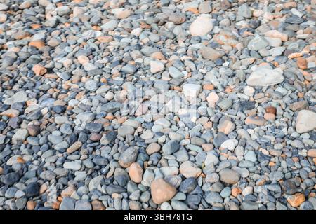 mooth pebbles background. variety of smooth, natural rocks with different shapes and textures Stock Photo