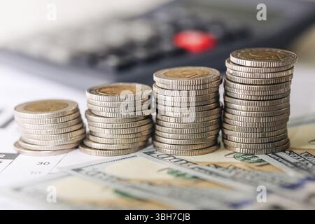 Coins stacked on cash. Budget and finance theme. Economic savings concept. Financial management background. Currency and wealth detail. Stock Photo